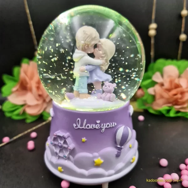 گوی شیشه ای بزرگ موزیکال پمپی برفی با شش طیف نوری طرح دختر و پسر I Love You رنگ یاسی